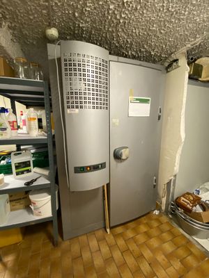 an image of a room with a refrigerator and shelves in it