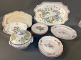 many different types of plates and bowls on the table