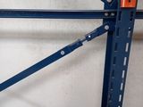 an orange and blue racking system in a warehouse