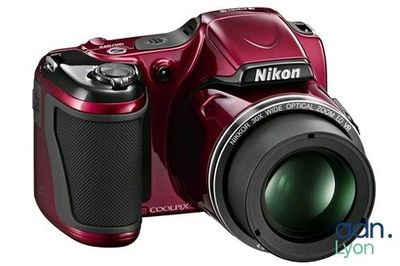 a close up of a red camera with a lens on it