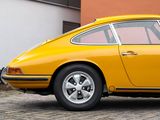 a yellow car that is parked in front of a building