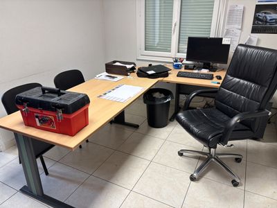 a desk with a chair and a computer on it