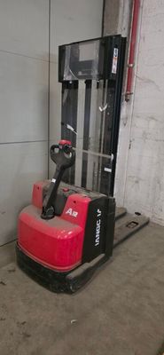 a red fork lift truck parked in a garage