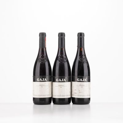 three bottles of wine sitting on top of a white table