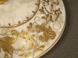 a plate with a gold ring on it on a table