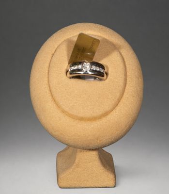 porte-bague en pierre jaune surmonté d'une bague en diamant