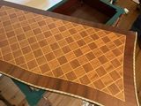 a table that has a wooden table top with a pattern on it