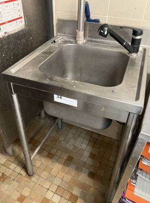 a sink in the middle of a kitchen with a faucet on it