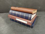 three books stacked on top of each other on a table