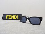 a pair of sunglasses sitting on a table next to a pen