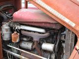 an old rusted truck with a rusty engine in the back of it