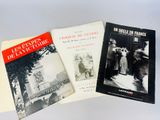 three books are sitting on a table with a white background