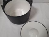 a black and white bowl and a white bowl on a table