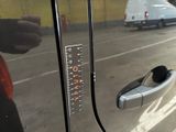 a close up of a car ' s door handle with a ruler on it