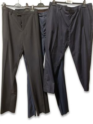 three pairs of pants hanging on a clothes rack in front of a white background