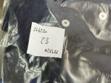 a picture of a shirt in a plastic bag with a label on it
