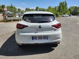 the rear end of a white car parked in a parking lot