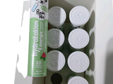 a box with a can of tea next to a can of lip balzer