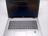 a laptop that is open on a white table