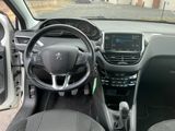 the interior of a small car with a steering wheel and dashboard