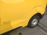 a yellow van that is parked on the side of the street