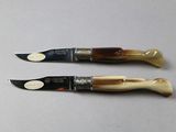 two knives that are sitting next to each other on a table