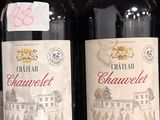 plusieurs bouteilles de vin sont alignées sur une étagère dans un magasin