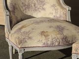 a chair and ottoman sitting in front of a wall