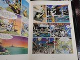 a comic book open to a page with a picture of a man on a boat