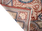 a close up of a red and blue rug with a clock on it