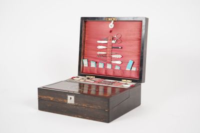 a small wooden box with a bunch of items inside of it
