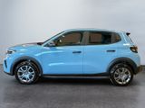 the blue suv is parked in a room with a gray floor