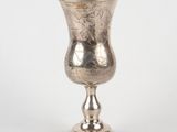 a silver cup that is sitting on a table