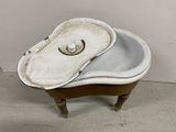 an old bathtub with a lid that is sitting on the floor