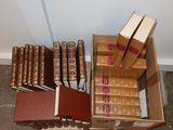 many books in a box on the floor next to each other