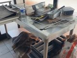 several pans and pans sit on a metal table in a kitchen