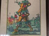framed picture of a man dressed in a costume with a hat and a sword