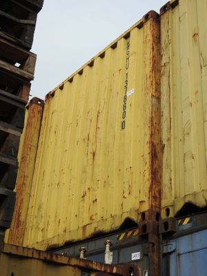 a yellow container sitting on top of a metal container