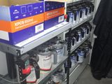 many cans of paint on the shelves in the store