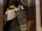 a wooden cabinet with a clock and other items in it