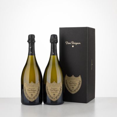 two bottles of champagne in front of a black box