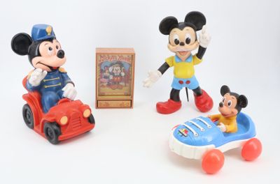 three mickey mouse figurines and a box of toys