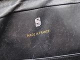 the inside of a black purse with a gold zipper on it