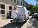 a white van that is parked in front of a building
