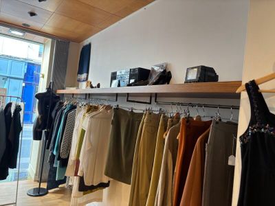 a lot of clothes hanging on a rack in a store