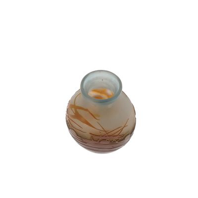 a glass vase with a brown and white design on it