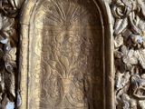 a gold door with carvings on the outside of it