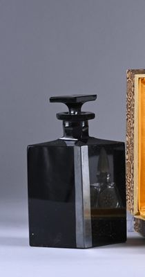 two bottles of perfume sitting next to each other on a table