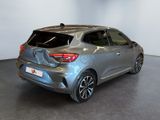 the rear end of a silver car in a showroom
