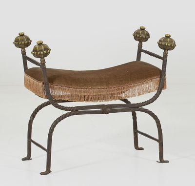 an iron bench with a brown seat and a brown cushion on it